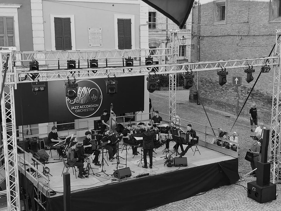 The Jazz Accordion Orchestra on stage in Piazza della Repubblica in Castelfidardo, with Renzo Ruggieri conducting